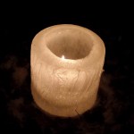 cylinder ice candle with a flame partially visible