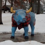 blue ox wearing a red-and-black plaid short-sleeved shirt