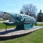 big green fish statue with white spots